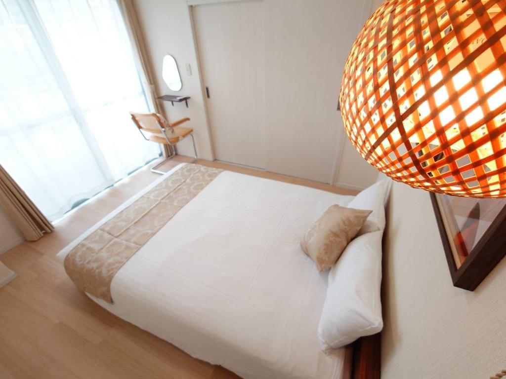 Postel nebo postele na pokoji v ubytování Neighbor's Hotel 十日市