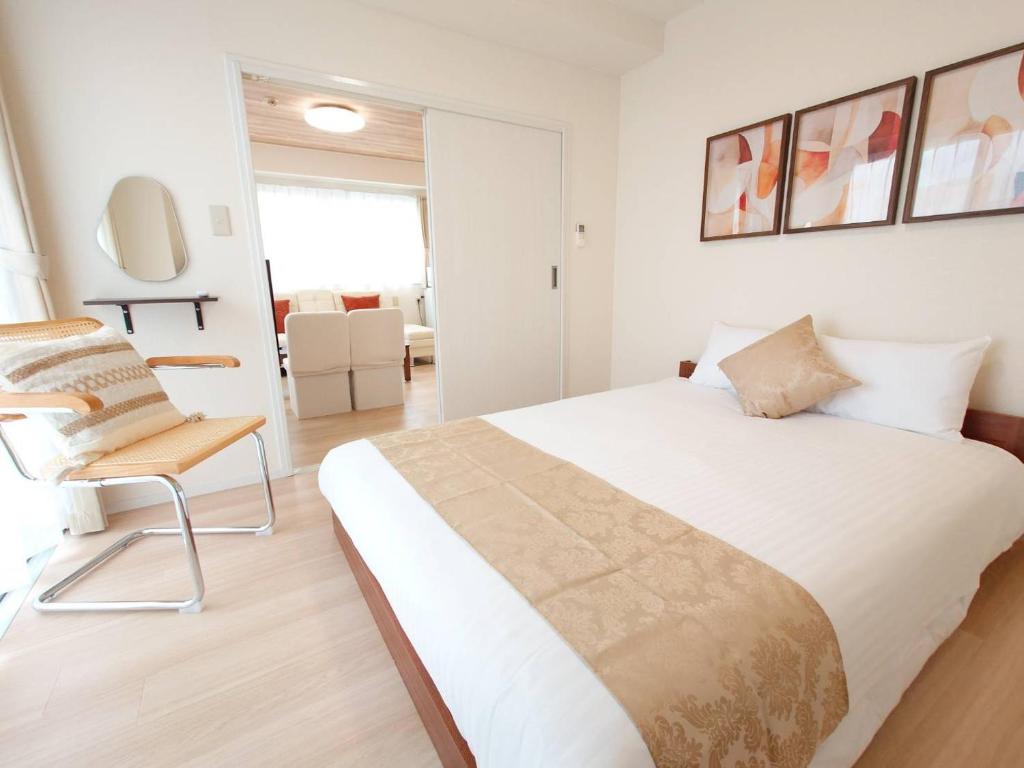 Postel nebo postele na pokoji v ubytování Neighbor's Hotel 十日市