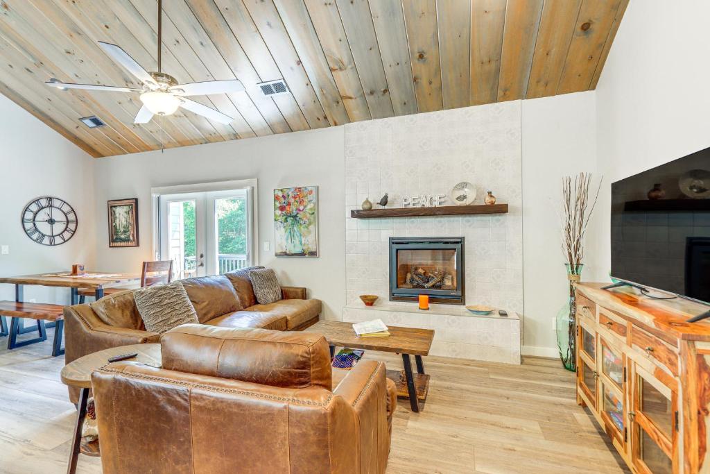 a living room with a couch and a fireplace at Hike, Fish and Kayak Murphy Gem with Deck and Fire Pit in Murphy
