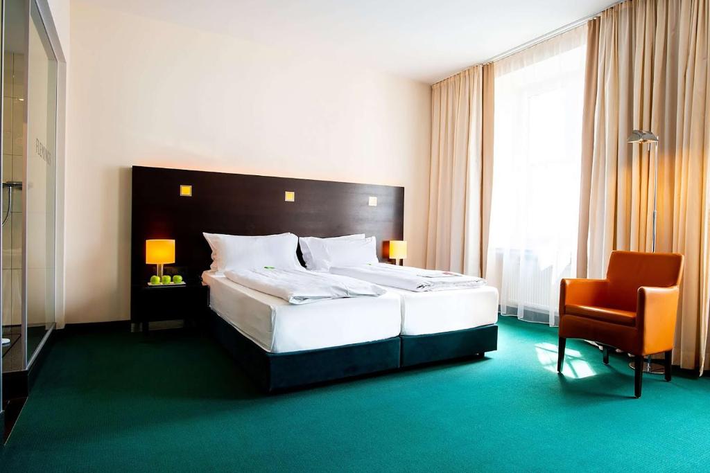 Postel nebo postele na pokoji v ubytování Flemings Hotel München-City