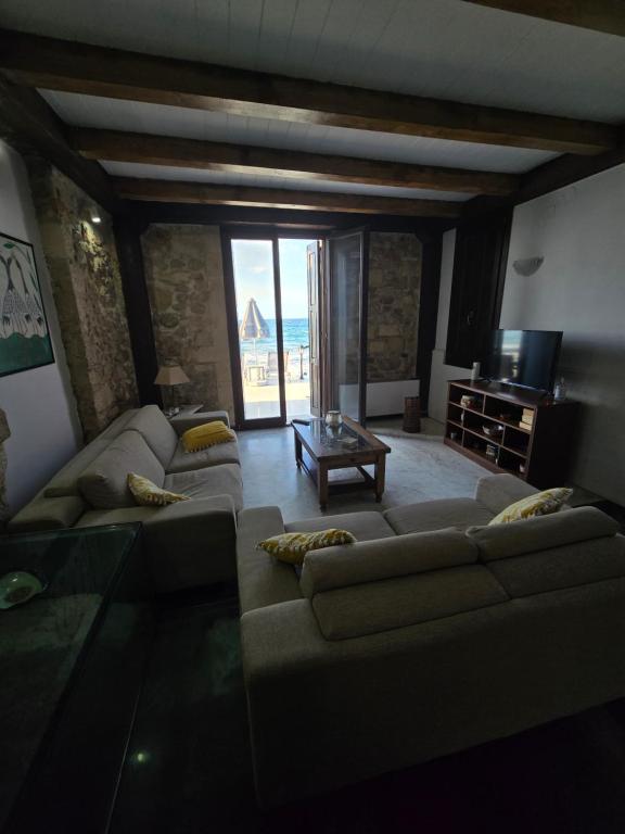 a living room with a couch and a table at Volakas Beachfront Suites in Rethymno
