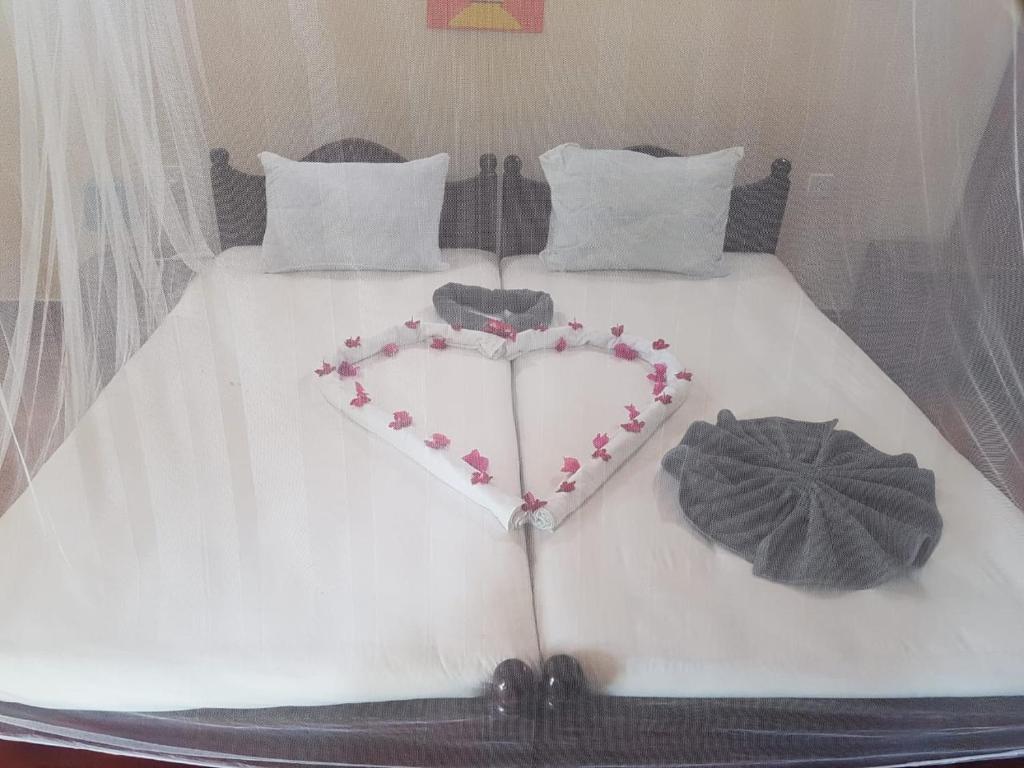 Postel nebo postele na pokoji v ubytování Secret Escape Nilaveli Ayurveda Hotel & Spa