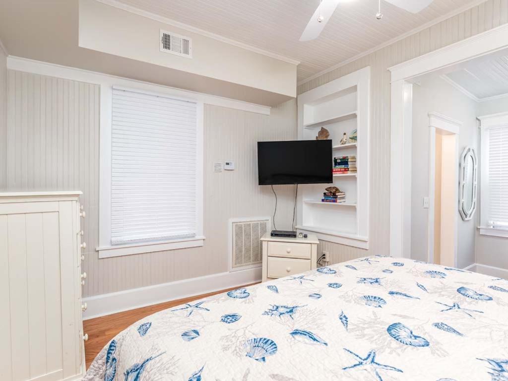 a bedroom with a bed and a flat screen tv at Sea View 3 in Tybee Island
