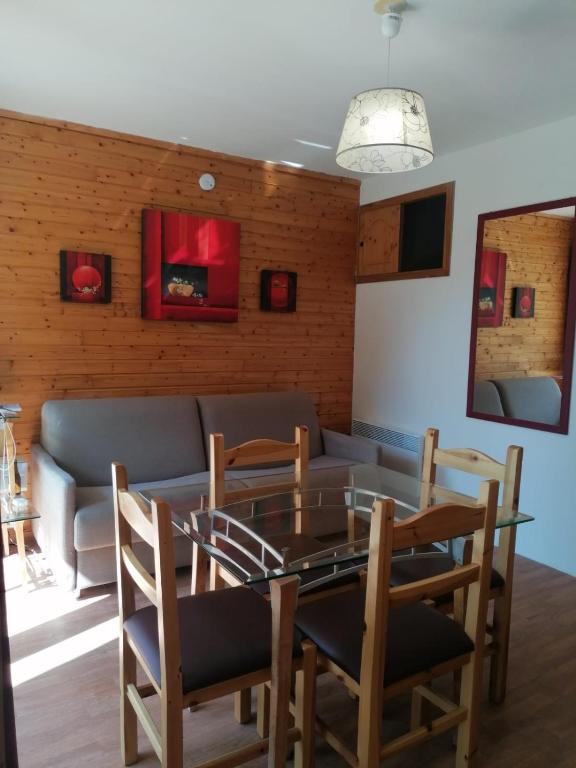 une salle à manger avec une table et des chaises en verre dans l'établissement Station ORELLE-VAL THORENS, app 4-6 pers, piscine et spa, à Orelle