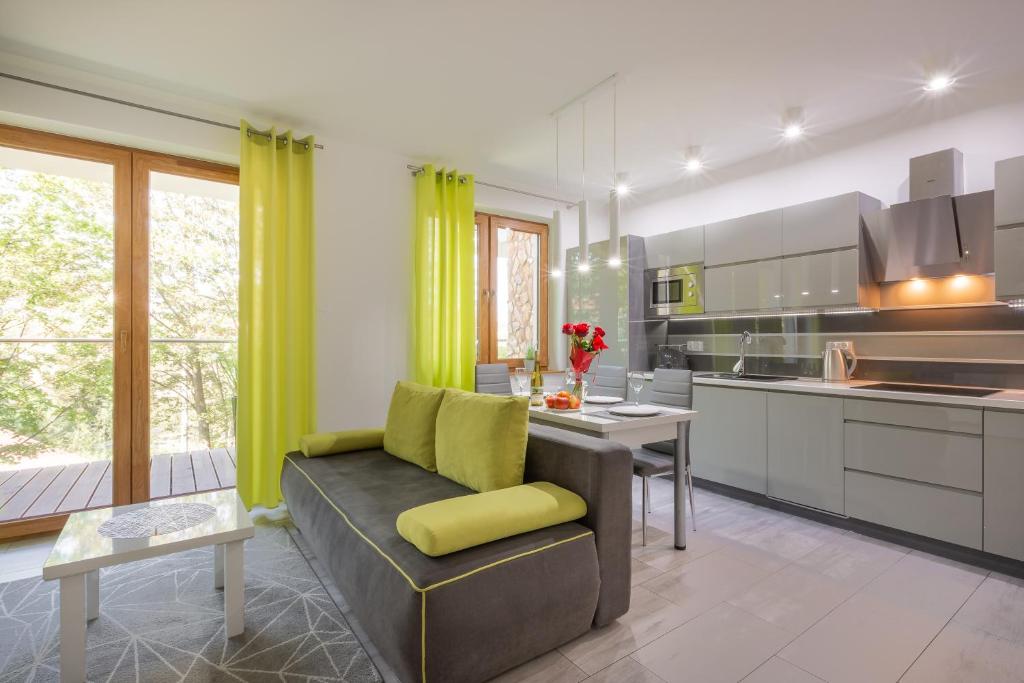 a living room with a couch and a kitchen at Górzysty I in Karpacz