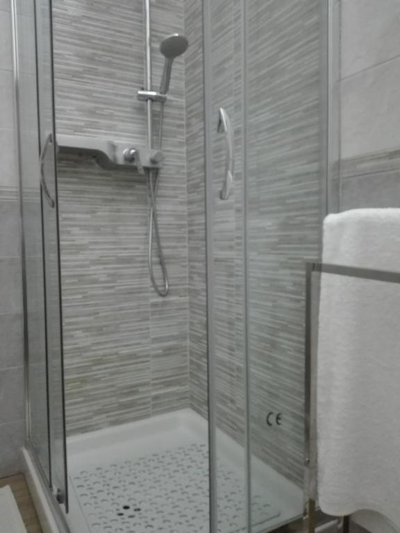 a shower with a glass door in a bathroom at B & B La Magnolia in Specchiolla