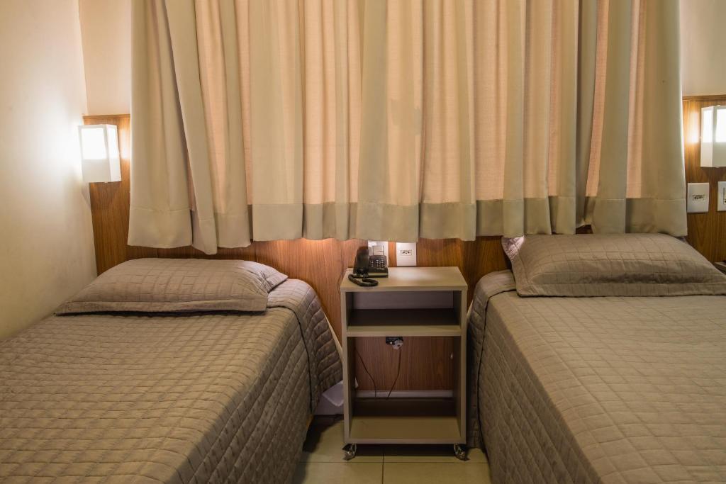 Postel nebo postele na pokoji v ubytování Hotel Trevo Cascavel