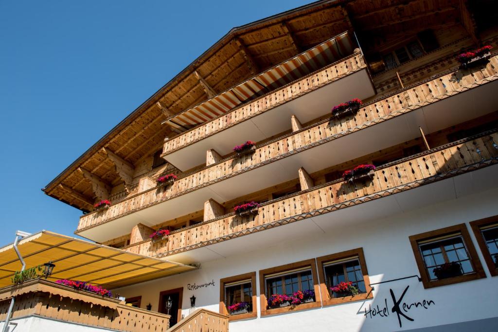 a building with balconies and flower boxes on it at Hotel Kernen in Gstaad