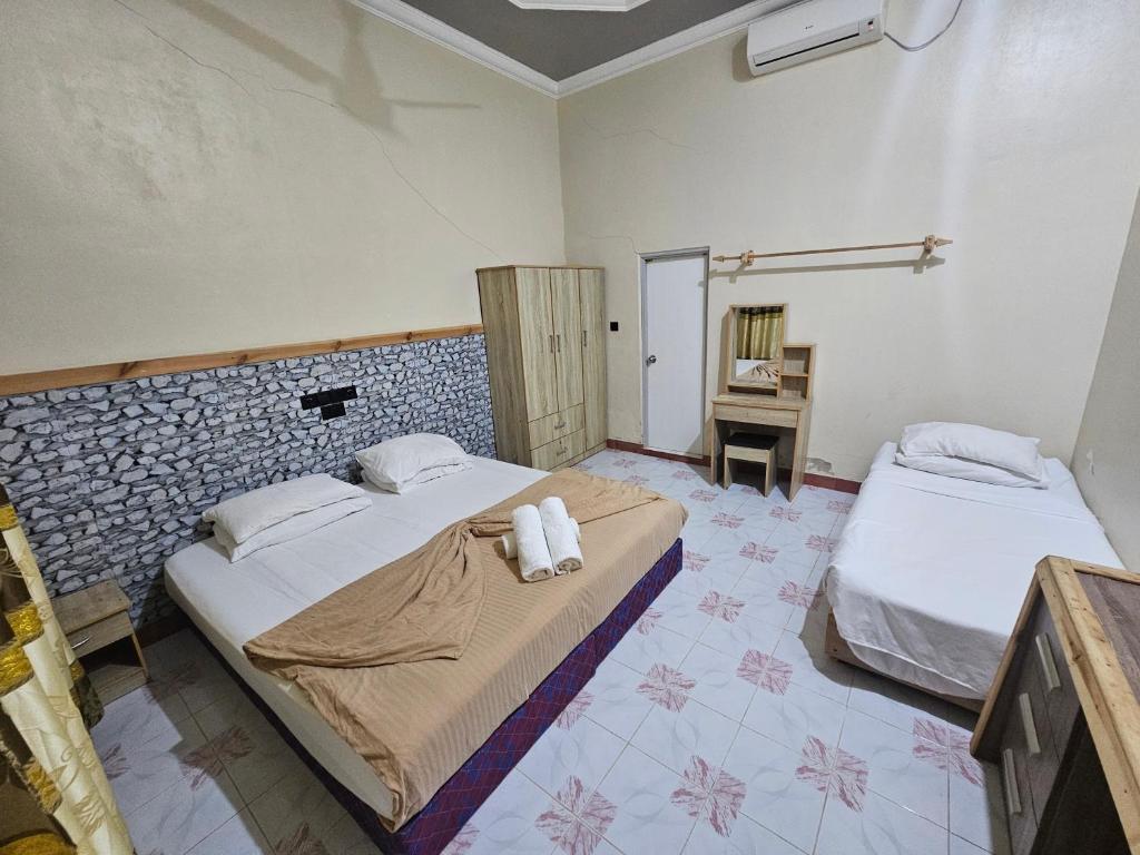 Postel nebo postele na pokoji v ubytování Coquillage Inn