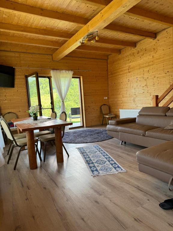 a living room with a couch and a table at Cabana Izvorul Rece Maramureş in Baia-Sprie