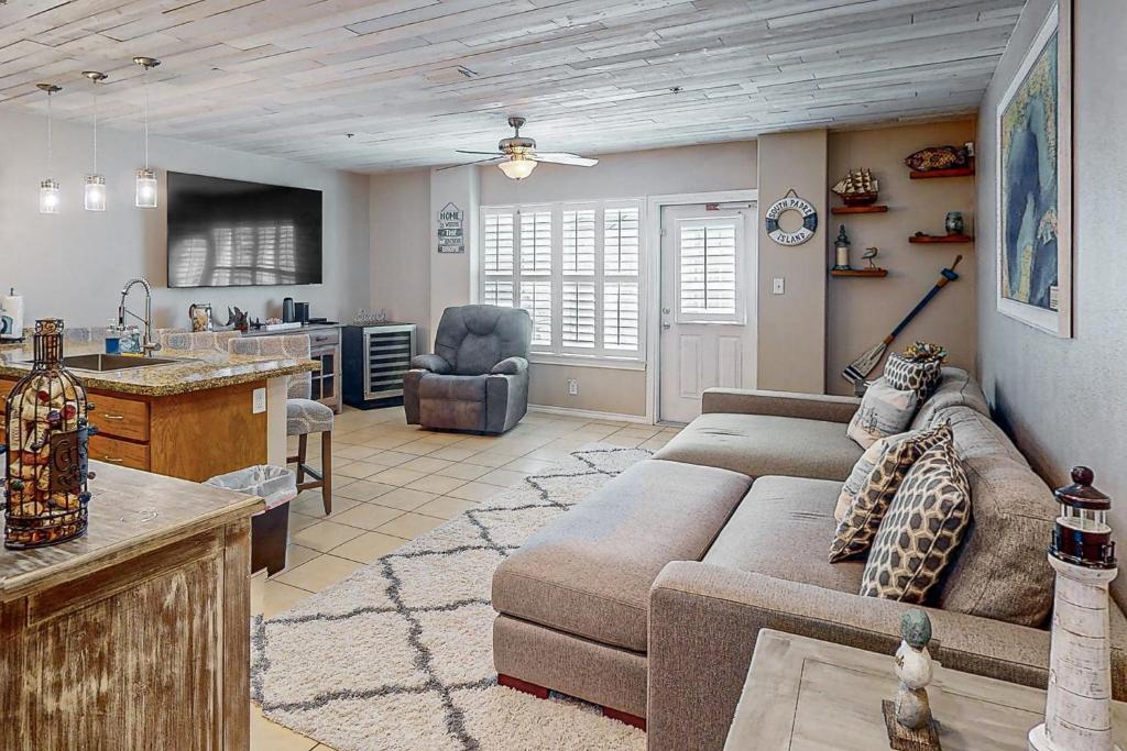 a living room with a couch and a kitchen at Star Beachside Condominiums 106 in South Padre Island