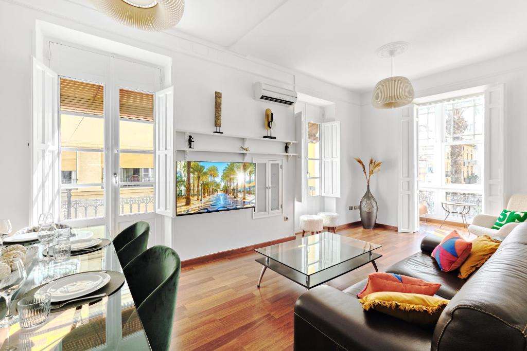 a living room with a couch and a glass table at 110m KKARA 3BR 2BA central Plaza Nueva view apt in Alicante