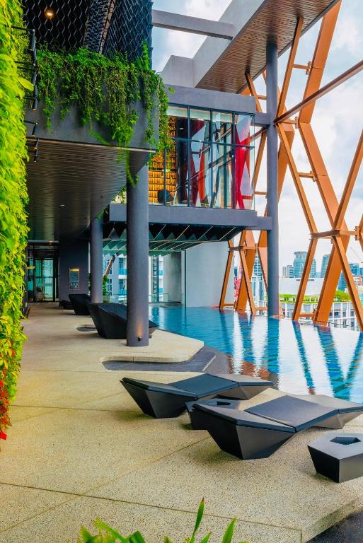 a building with a pool in the middle of it at Scarletz Suites KLCC by M Suites in Kuala Lumpur