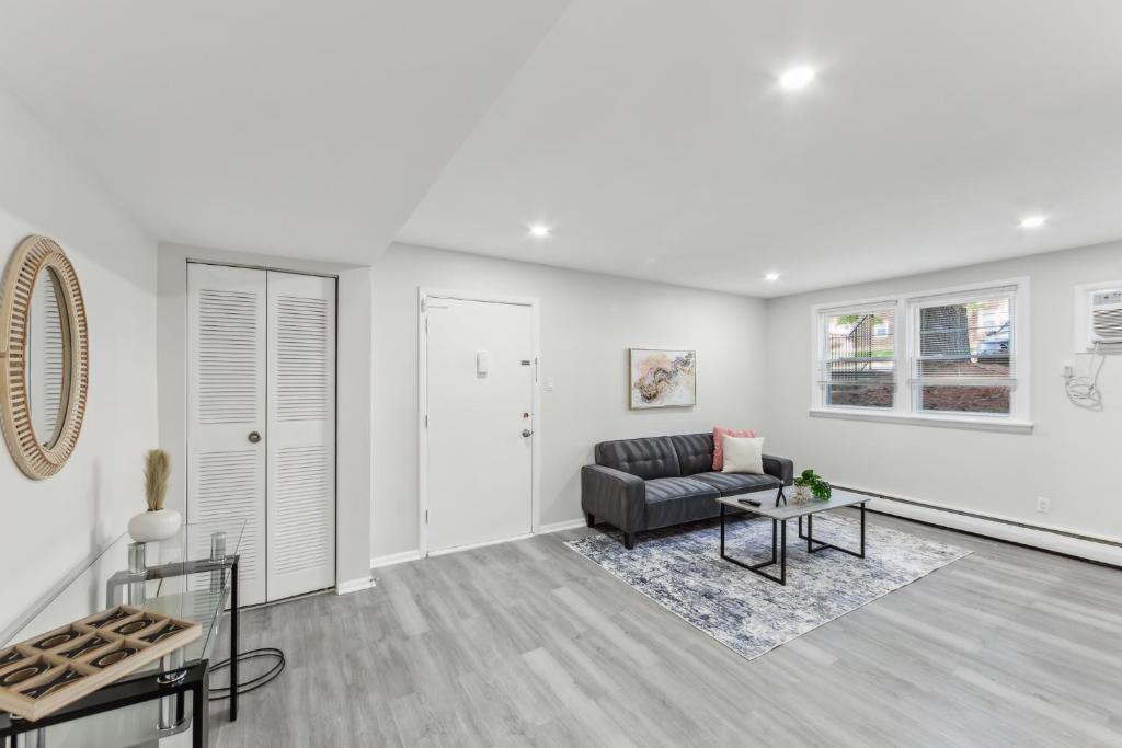 a living room with a couch and a table at Pine Brook 416 I Corporate 15Br Apartment ! Pool in Newark