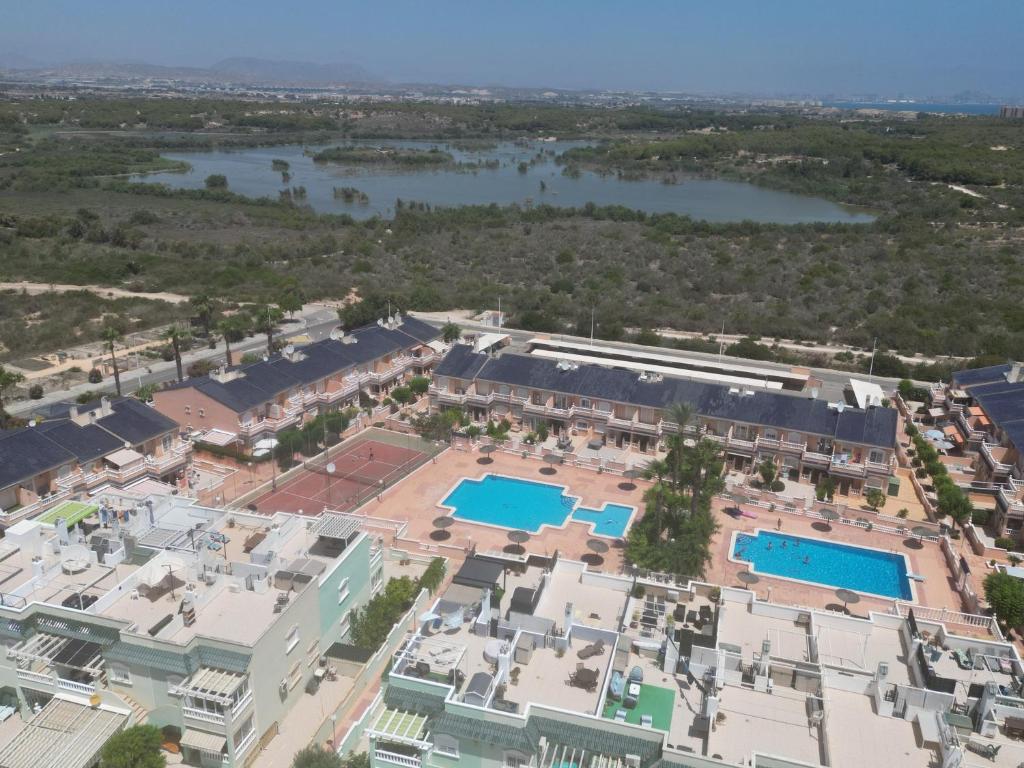 an aerial view of a resort with two pools at Bungalow Carabassi Mediterraneo 3 Pool and roof terrace in Puerto Marino