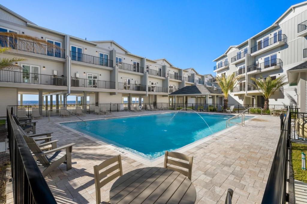 a swimming pool in front of a building at One More Time Again by Pristine Properties Vacation Rentals in Mexico Beach