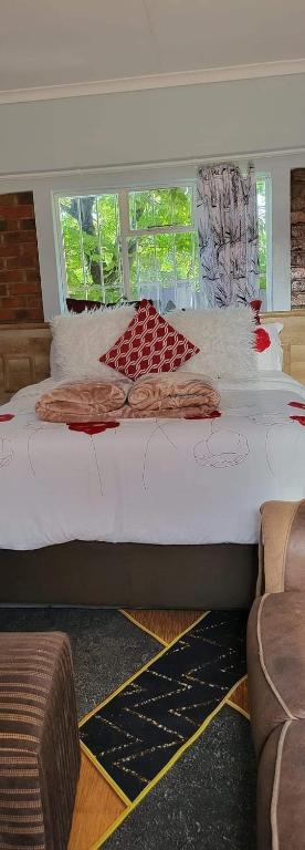 a large bed in a room with a window at Goodlife guest house in klerksdorp in Klerksdorp