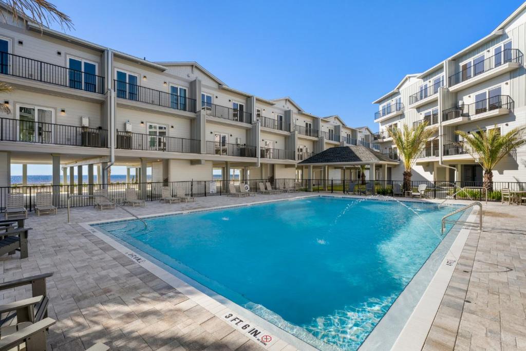a swimming pool in front of a building at One More Time Again by Pristine Properties Vacation Rentals in Mexico Beach