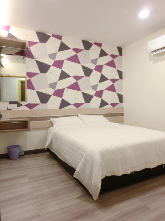 Postel nebo postele na pokoji v ubytování Hotel Alor Gajah