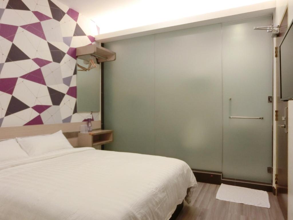 Säng eller sängar i ett rum på Hotel Alor Gajah