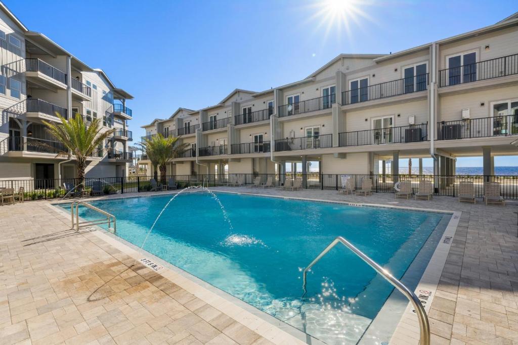 a swimming pool in the courtyard of a apartment building at One More Time Again by Pristine Properties Vacation Rentals in Mexico Beach