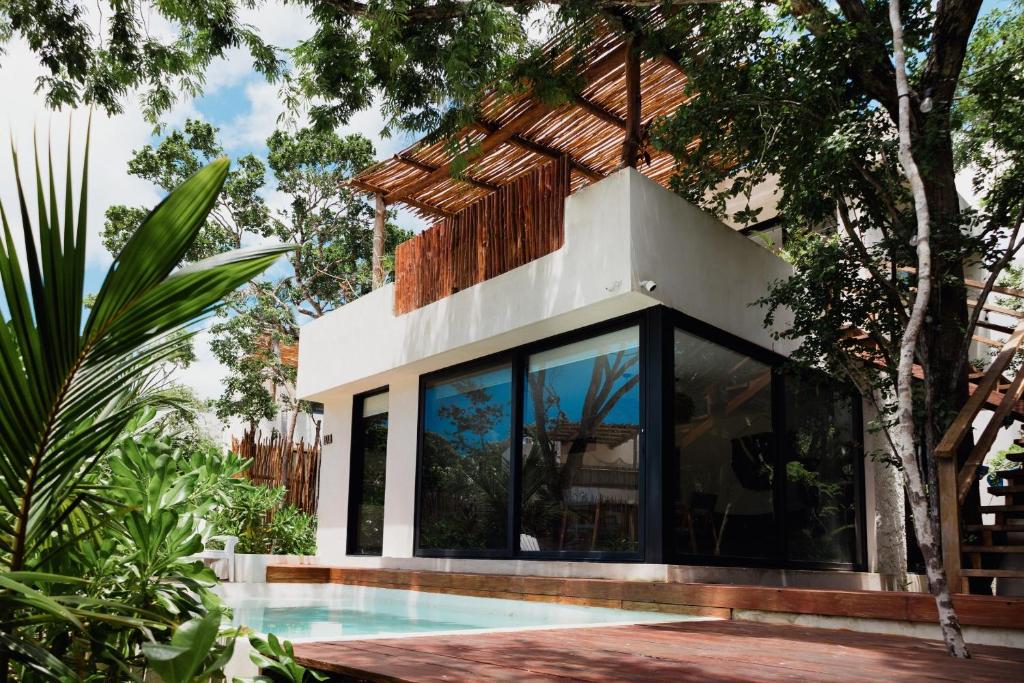 a house with a swimming pool in a garden at Deluxe Tulum Villa KIIN in Tulum
