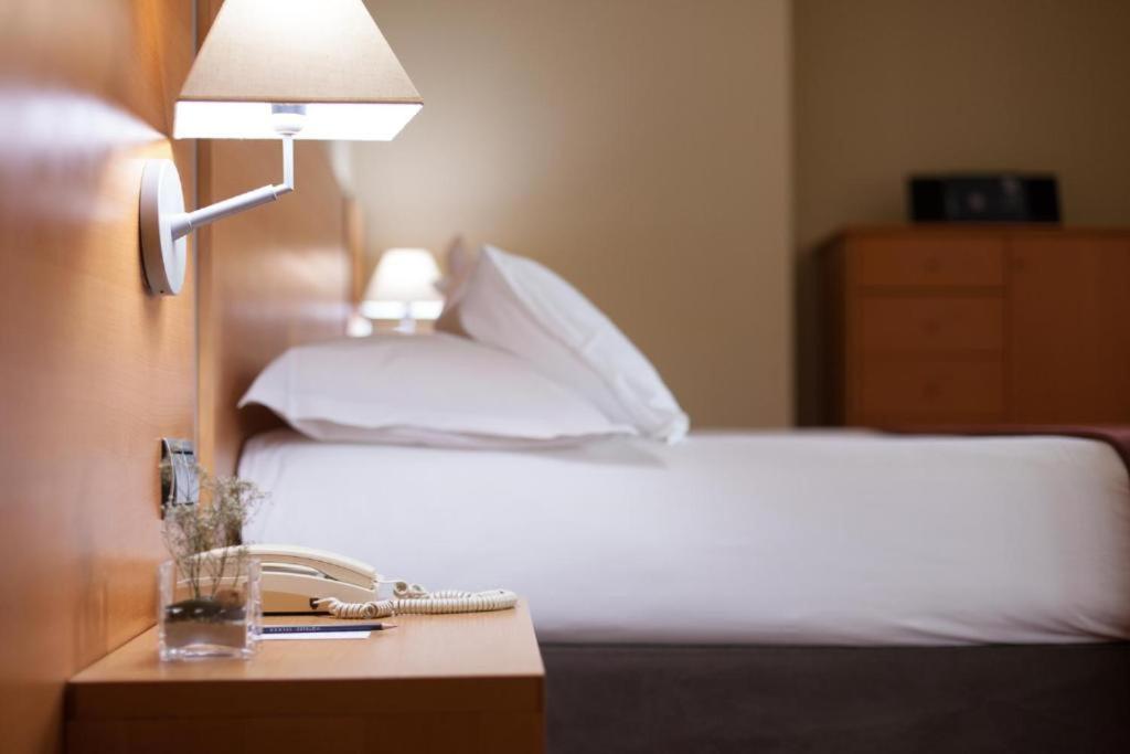 Ένα ή περισσότερα κρεβάτια σε δωμάτιο στο Hotel Plaza San Lazaro