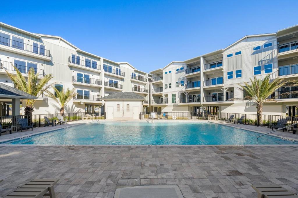 a swimming pool in the courtyard of a apartment building at Sharkey's by Pristine Properties Vacation Rentals in Cape San Blas
