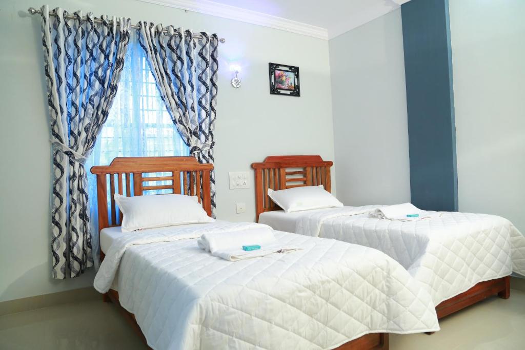 Postel nebo postele na pokoji v ubytování Anna Residency