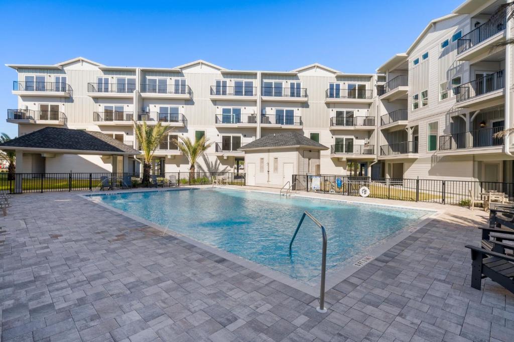 a swimming pool in front of a apartment building at One More Time Again by Pristine Properties Vacation Rentals in Mexico Beach