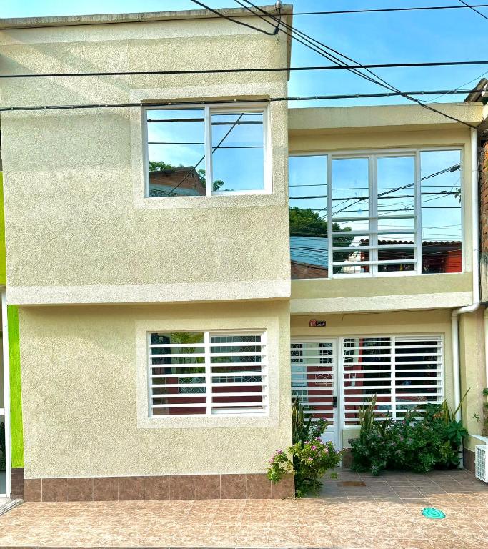 a house with windows and a view of the ocean at Habitaciones tipo hotel con terraza in Ibagué