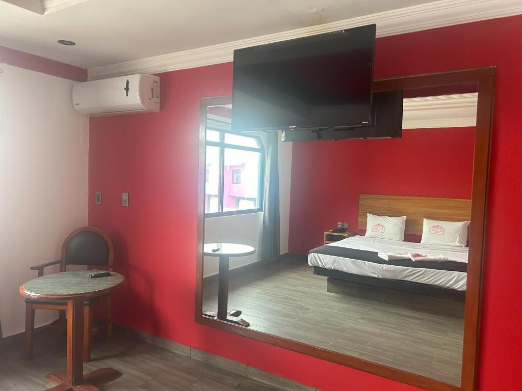 Postel nebo postele na pokoji v ubytování Auto Hotel El Cine