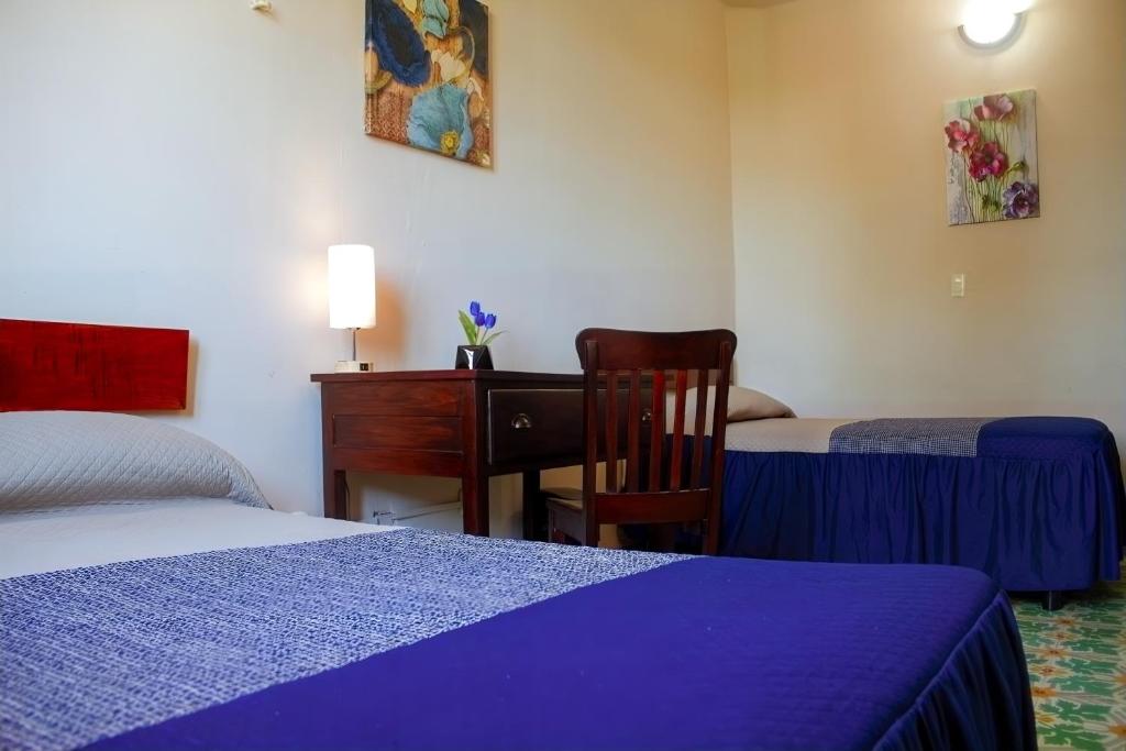 Postel nebo postele na pokoji v ubytování Hotel Cortaza Galería