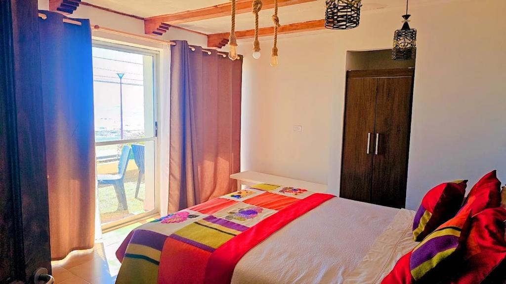Una cama o camas en una habitación de Hosteria Iloca