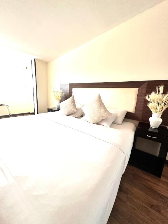 Postel nebo postele na pokoji v ubytování HOTEL SHERIDAN BOGOTA