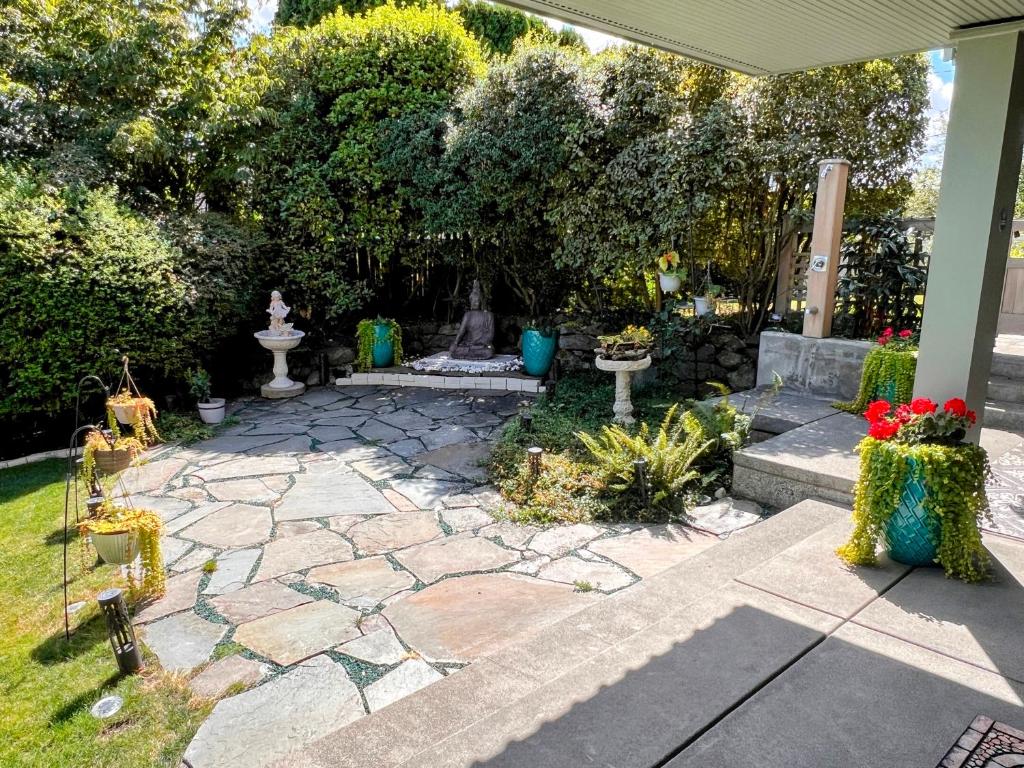a garden with a stone patio with a fountain at Seasons at Leschi Hillsides in Seattle