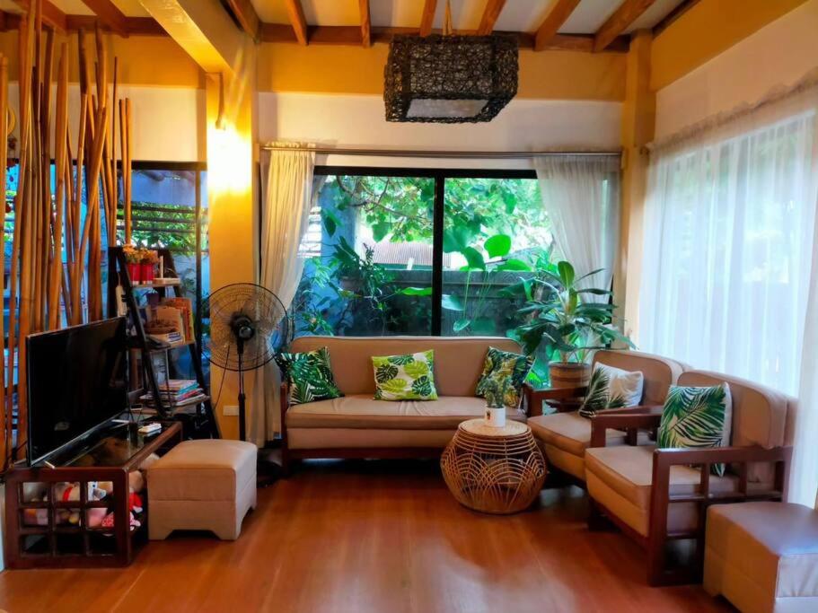 a living room with a couch and a tv at House of Bela in Iloilo City