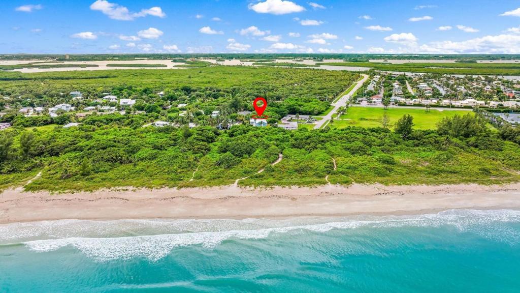 an aerial view of a beach with a red stop sign at No-Stairs Beach Getaway - Ground Floor Pet-Friendly 2BR in Fort Pierce
