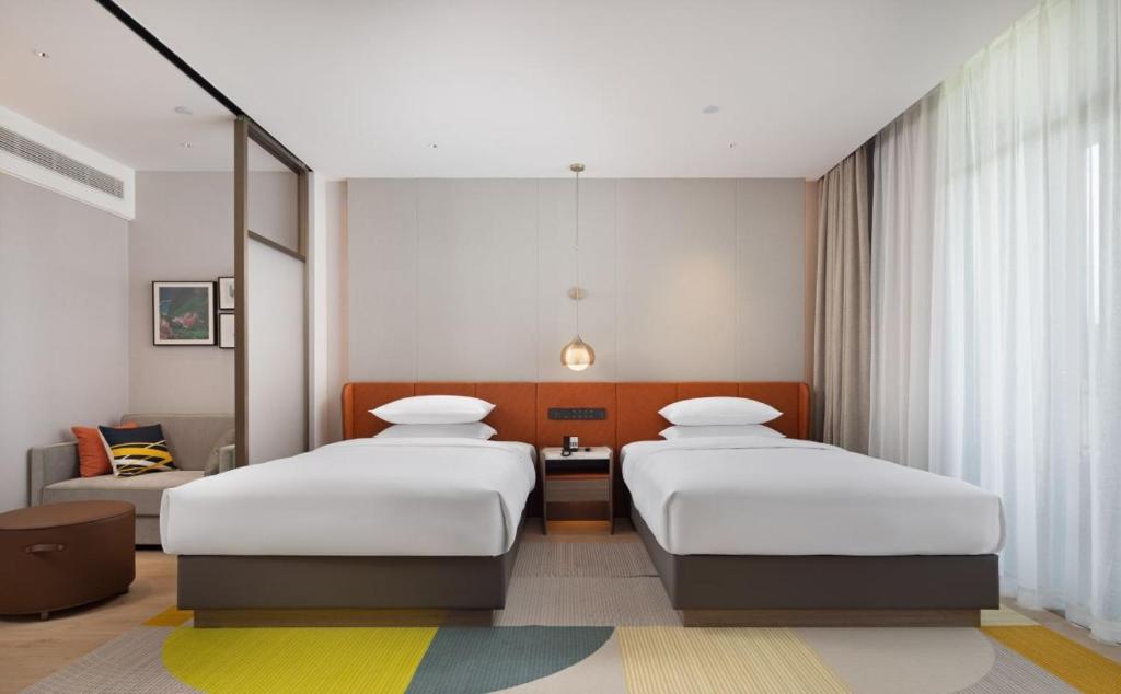 Postel nebo postele na pokoji v ubytování Home2 by Hilton Chongqing Wushan