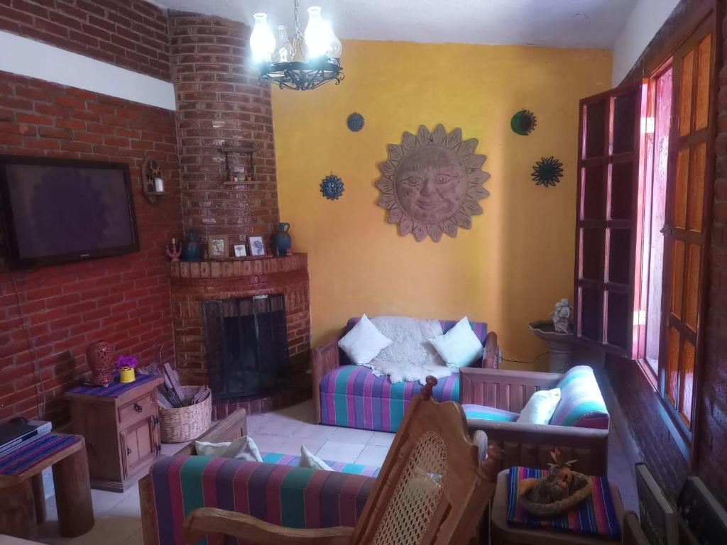 a living room with a couch and a fireplace at AranCalli, hospedaje en cabañas in Ozumba de Alzate