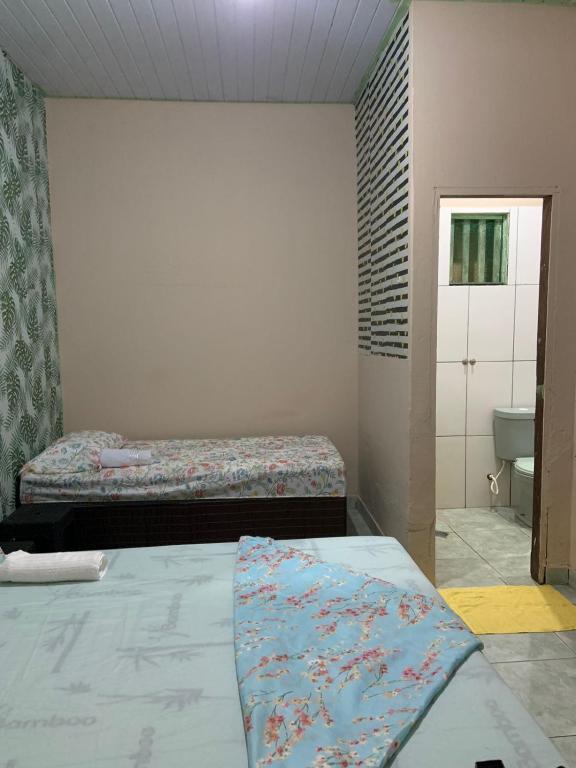 Postel nebo postele na pokoji v ubytování KitNet com cozinha e ar