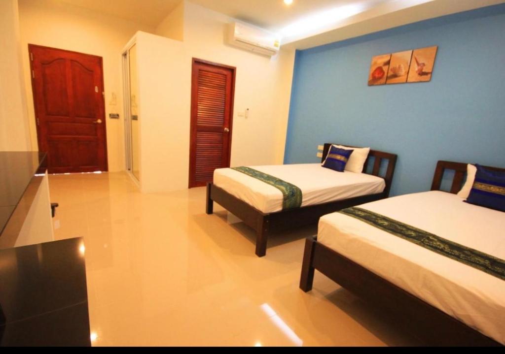 Postel nebo postele na pokoji v ubytování Phangan Guest House