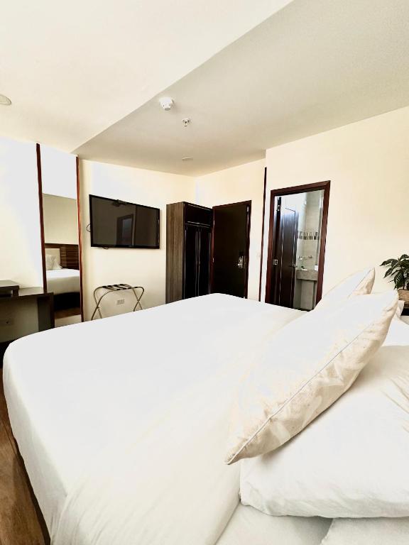 Postel nebo postele na pokoji v ubytování HOTEL SHERIDAN BOGOTA