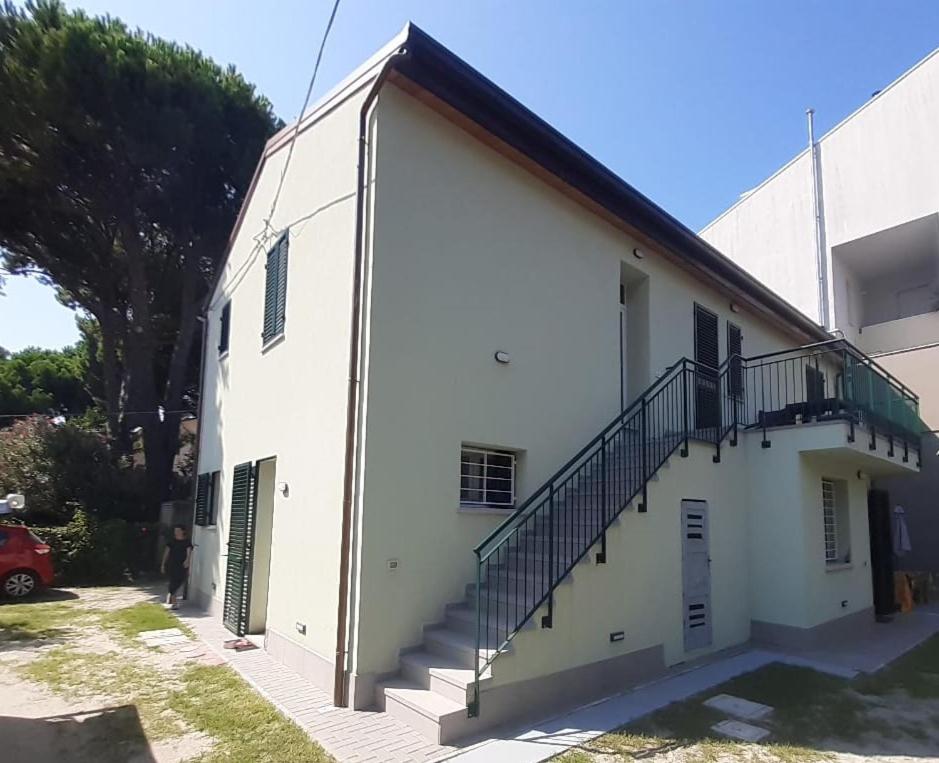 a white building with stairs on the side of it at Da Zia Vecchia in Cervia