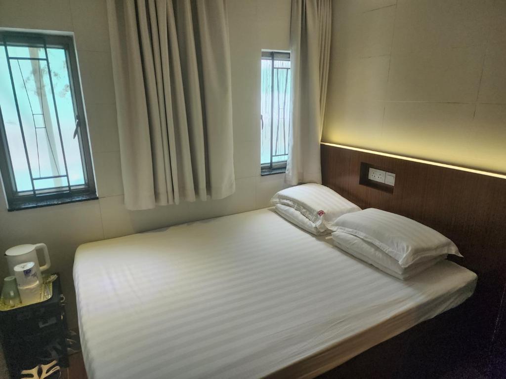Voodi või voodid majutusasutuse 香港金門賓館 KamMun Guest House toas