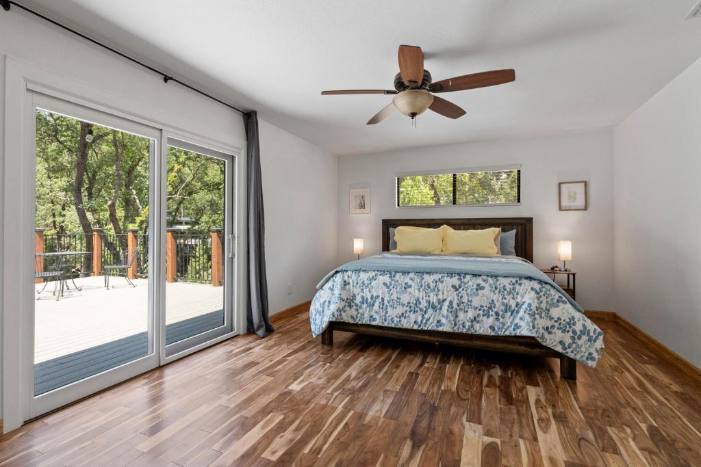 a bedroom with a bed and a ceiling fan at Peaceful Creekside Buddha Retreat in Groveland