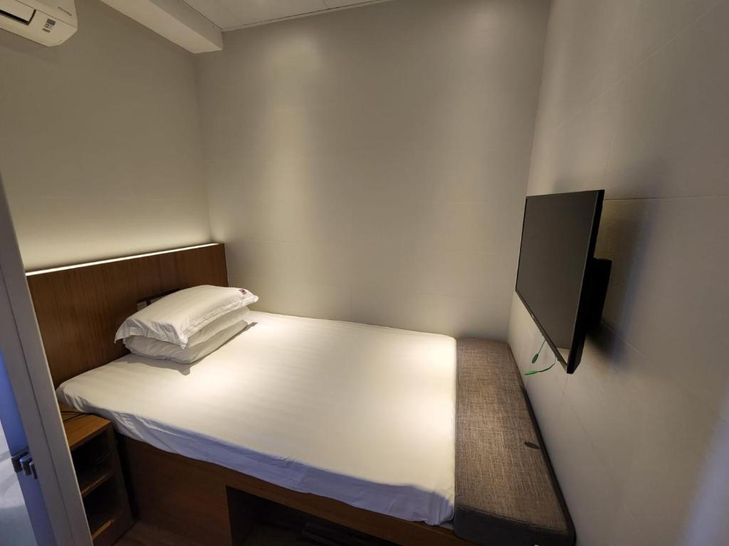 Voodi või voodid majutusasutuse 香港金門賓館 KamMun Guest House toas