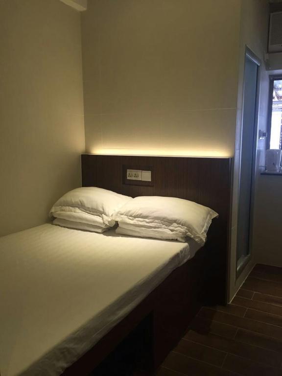 Voodi või voodid majutusasutuse 香港金門賓館 KamMun Guest House toas