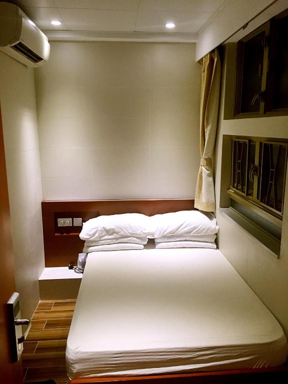 Voodi või voodid majutusasutuse 香港金門賓館 KamMun Guest House toas