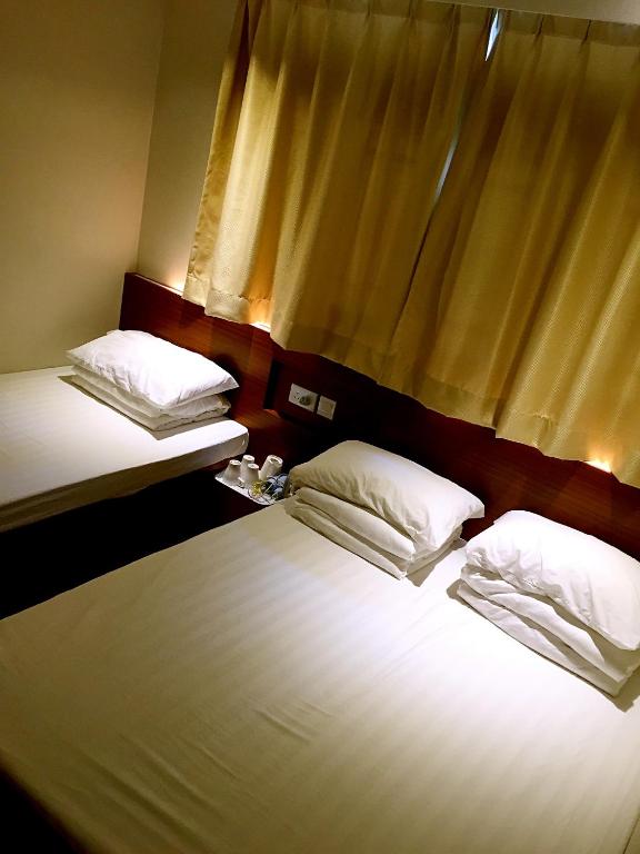 Voodi või voodid majutusasutuse 香港金門賓館 KamMun Guest House toas